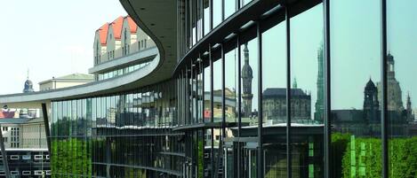 A modern building with large glass windows and a curved roof.