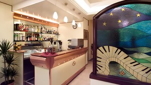A bar area with a counter, shelves of bottles, and a decorative glass wall with a starry design. - Luna Rossa (Naples)