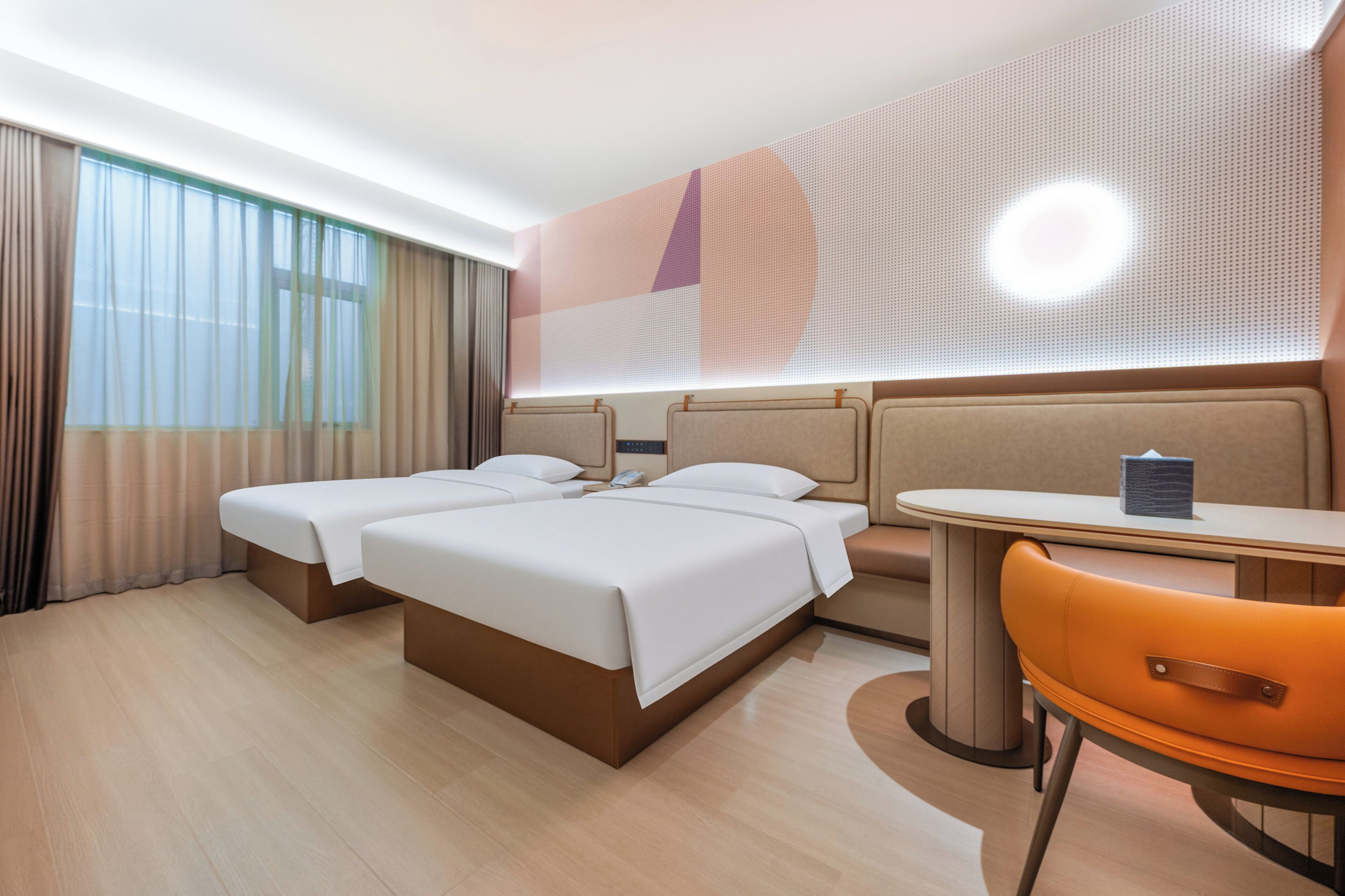 A hotel room with a bed, two bedside tables, a chair, and a desk.