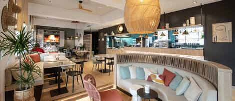A modern interior with a curved sofa, dining area, and bar.
