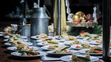 A buffet table with various dishes.