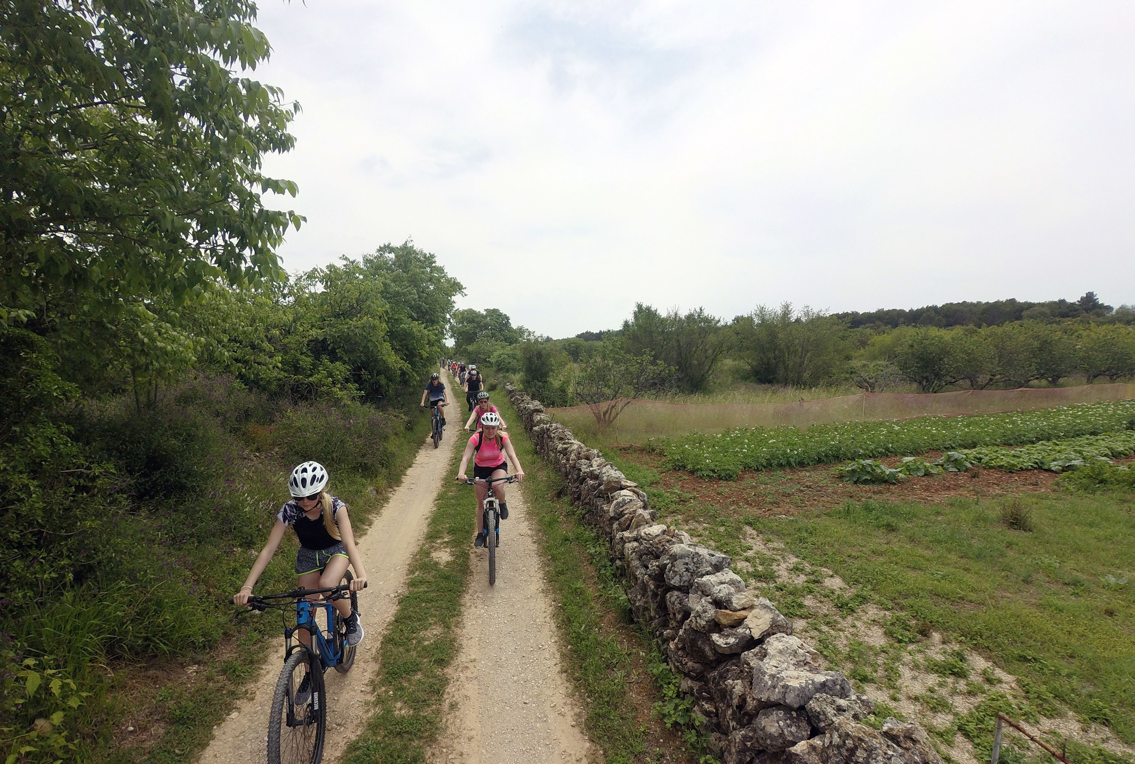 A dirt path with cyclists.