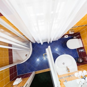 A bathroom with a shower, toilet, sink, and a bathtub. - William Sivek Hotels (Prague)