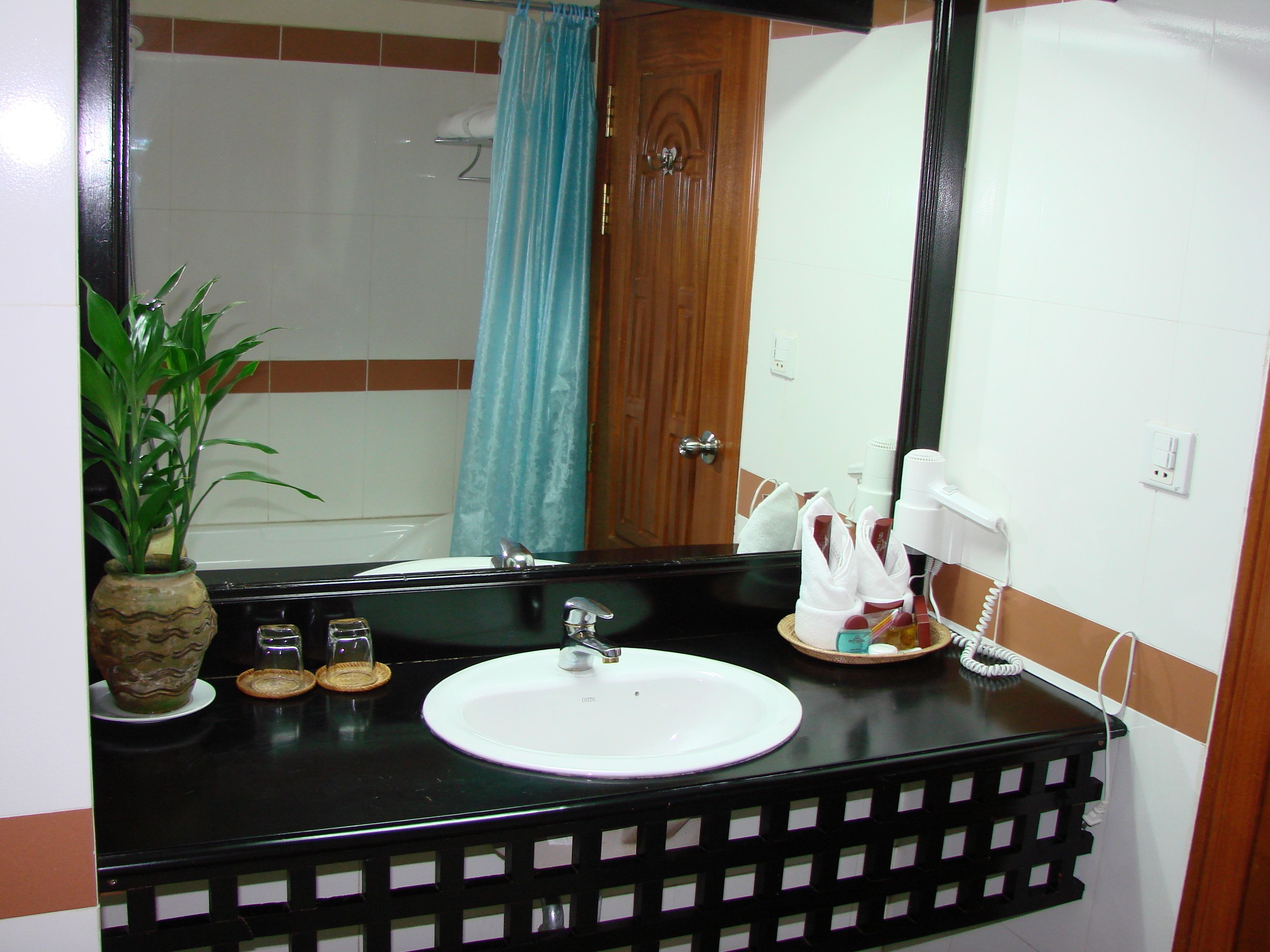 deluxe double room, 1 king bed | bathroom | combined shower/bathtub, designer toiletries, hair dryer, slippers