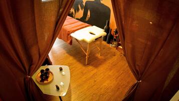 Relax in this inviting room with a bed under a large window and a small table with a few personal touches.