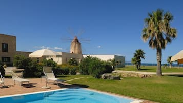 Seasonal outdoor pool, open 11:00 AM to 6:00 PM, pool umbrellas