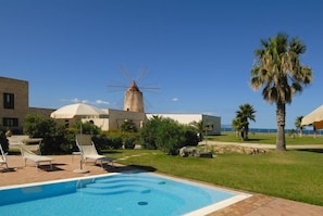 Seasonal outdoor pool, open 11:00 AM to 6:00 PM, pool umbrellas