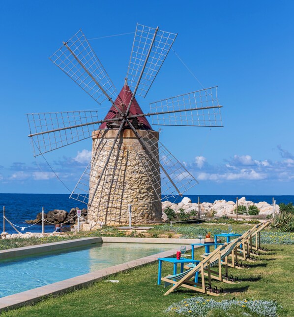 Seasonal outdoor pool, open 11:00 AM to 6:00 PM, pool umbrellas