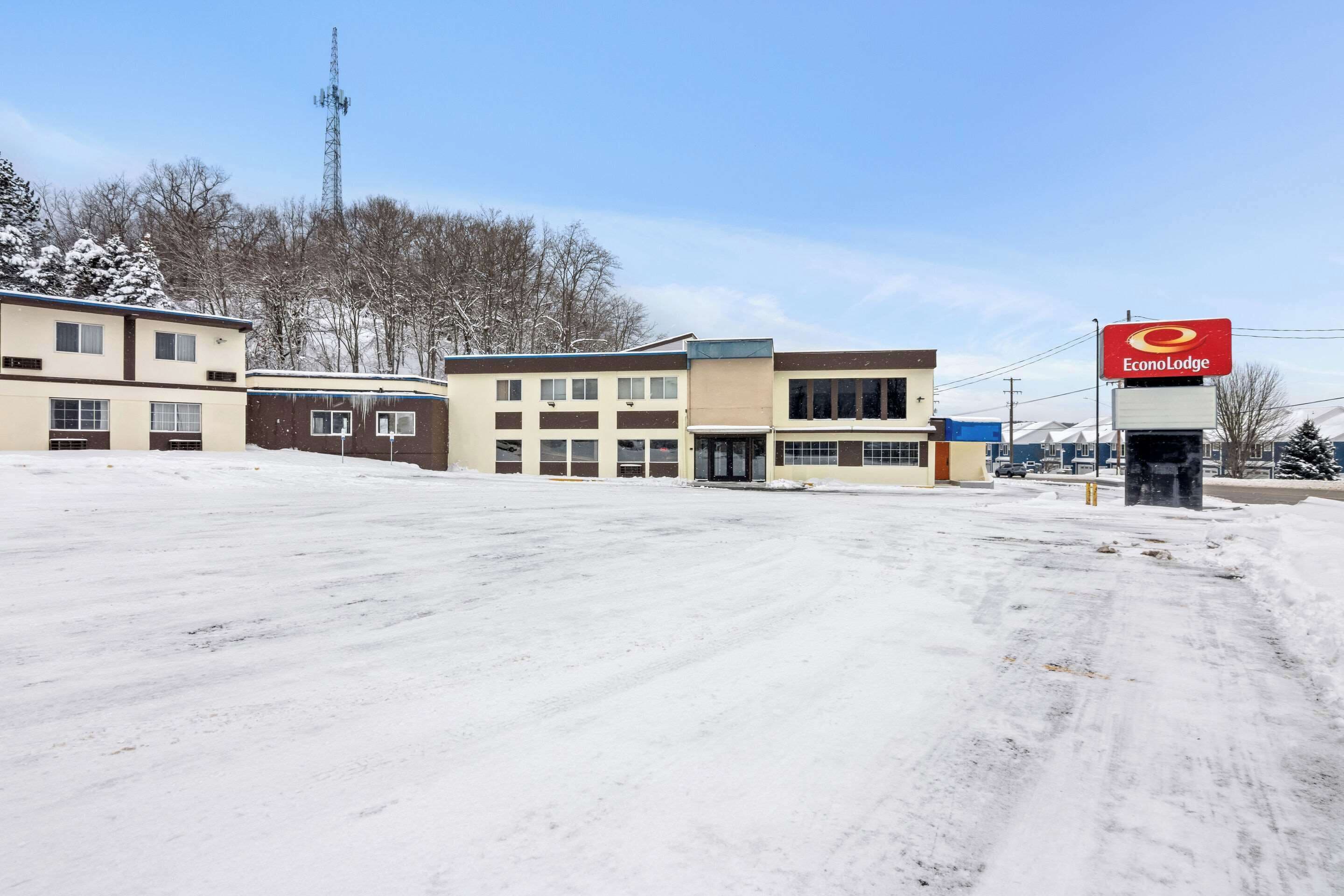 A commercial area with a building labeled "EconoLodge" and a snow-covered parking lot.