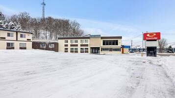 A commercial area with a building labeled "EconoLodge" and a snow-covered parking lot.