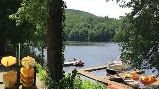 Une jetée au bord du lac, avec des bateaux et une table de pique-nique.