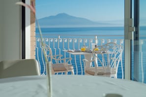 Enjoy breathtaking views of the sea and distant mountains from this room's balcony.