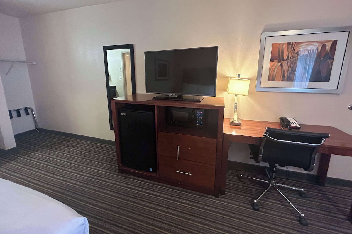 Desk, laptop workspace, blackout drapes, iron/ironing board