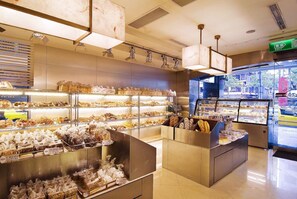 A bakery display with various baked goods and pastries. - San Want Hotel Taipei (Taipei)