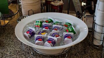 A bowl filled with ice and various frozen treats.