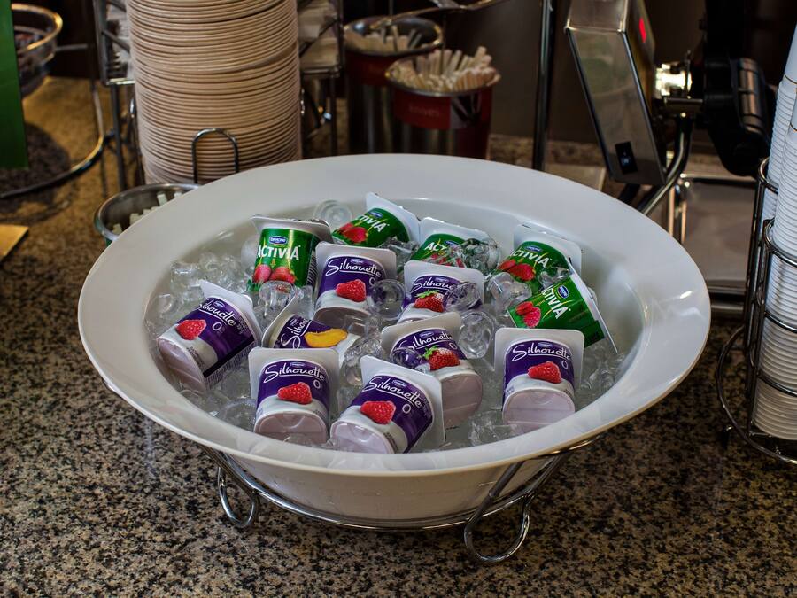 A bowl filled with ice and various frozen treats.