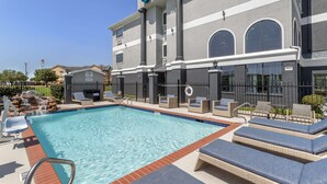 A hotel with a swimming pool, outdoor seating, and a sign reading "Best Western." - Best Western Texas City I-45 (Texas City)
