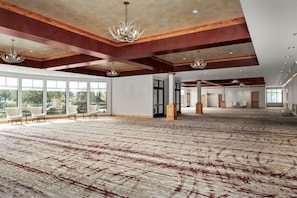 A spacious hall with large windows, wooden beams, and chandeliers. - Hilton Garden Inn Missoula (Missoula)