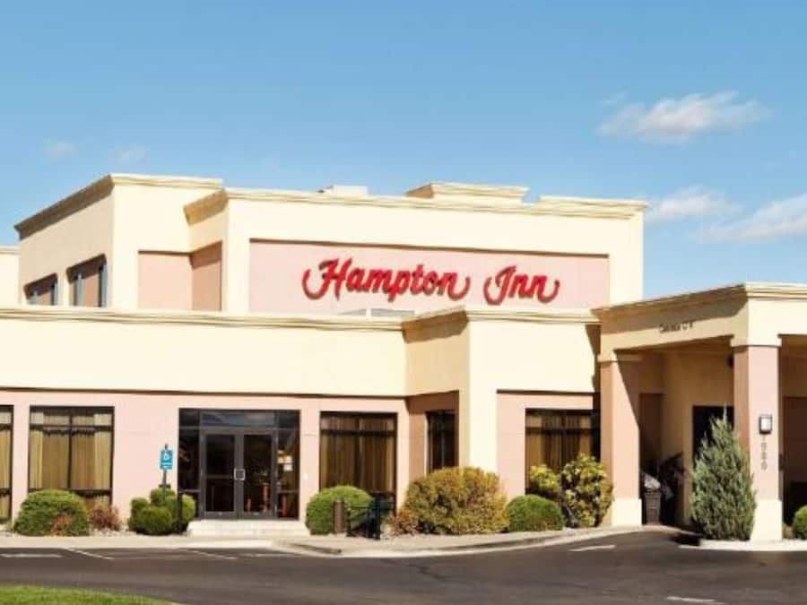 A Hampton Inn hotel with a two-story structure, a prominent entrance, and a parking lot.