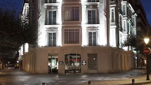 A multi-story building with a sign reading "HOTEL AC BURGOS" at the top.