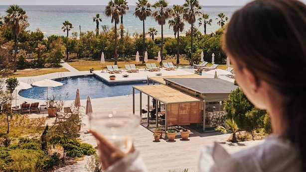 A resort with a pool, lounge chairs, and palm trees. - Sabàtic Gavà Mar, Barcelona, a Tribute Portfolio Hotel (Gava)