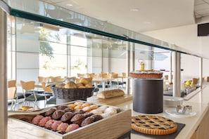 A buffet with various baked goods and pastries.