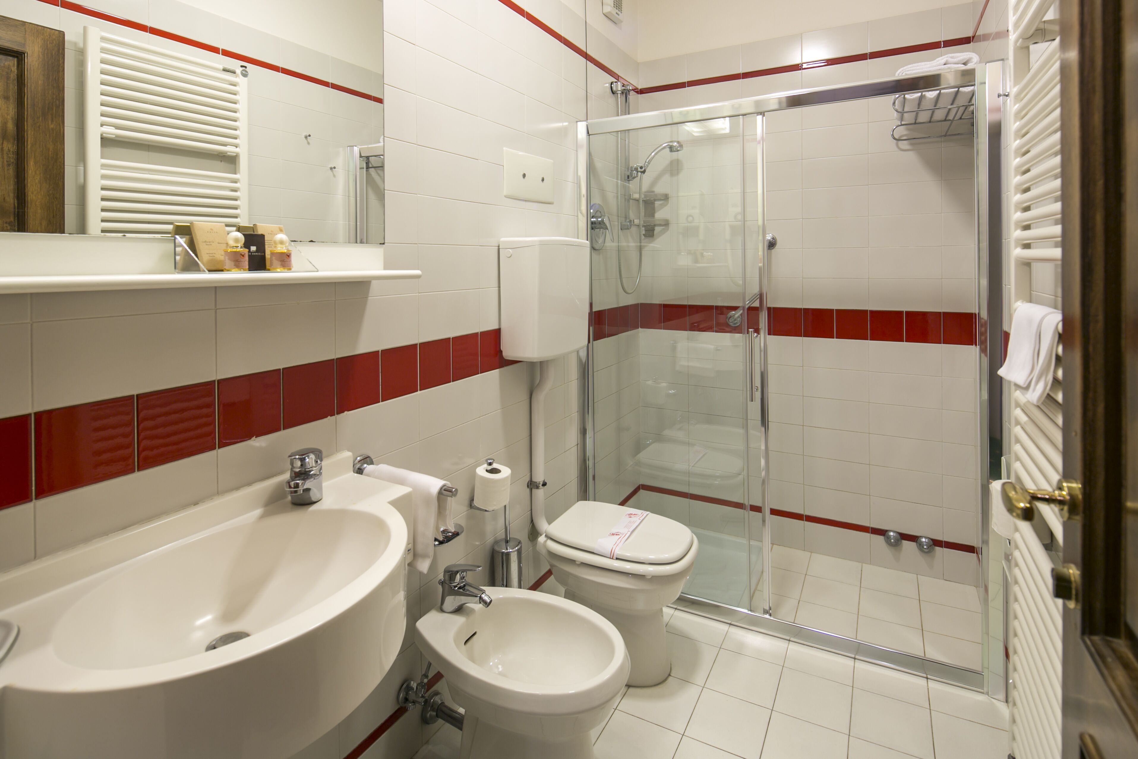 A bathroom with a bathtub, a shower, a toilet, and a sink.