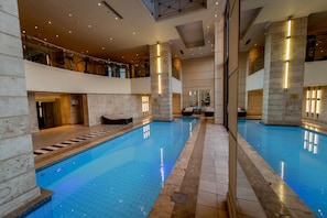 Relax by the pool surrounded by a spacious deck and comfortable seating areas.