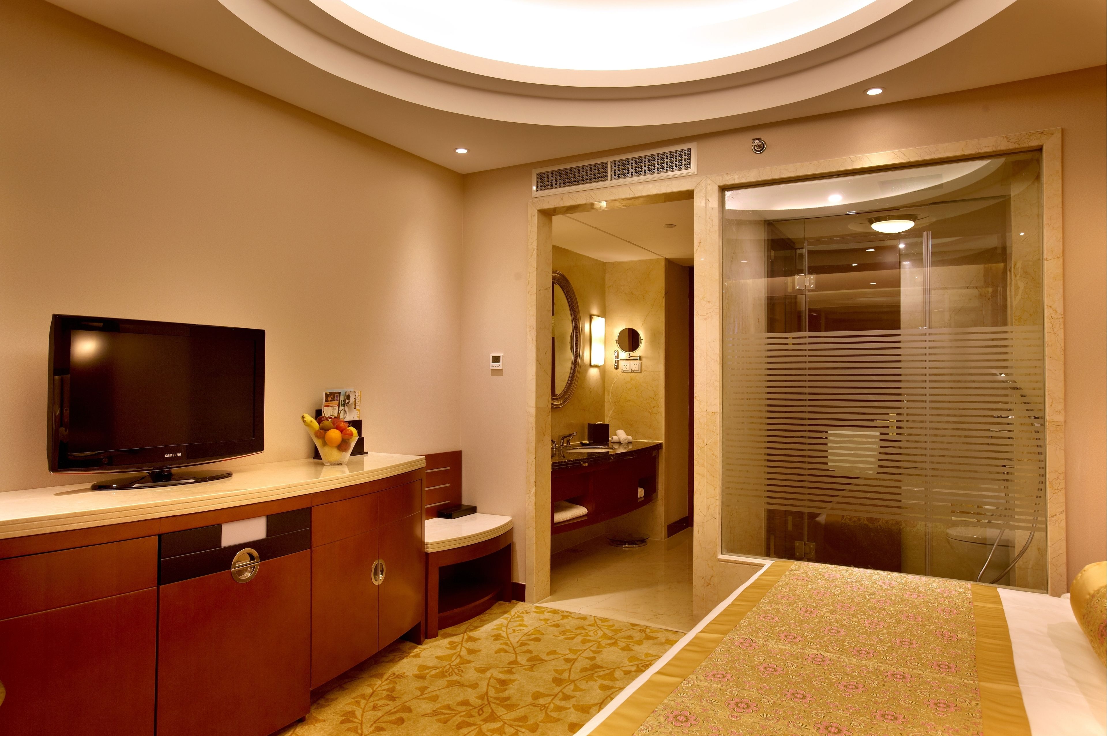 A modern bathroom with a vanity, toilet, and shower area.