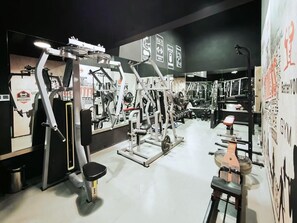 A gym with various exercise machines, mirrors, and motivational posters. - New Beacon International Hotel - Shanghai (Shanghai)
