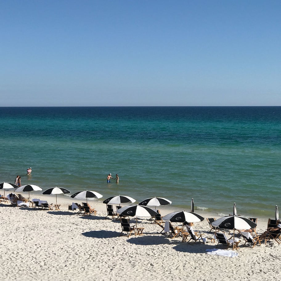 On the beach, white sand, sun loungers, beach umbrellas