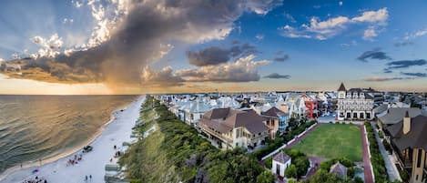 A coastal town with a beach, houses, and a prominent church.