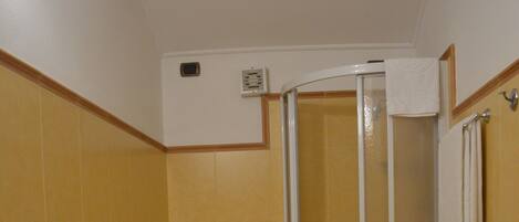 A bathroom with a sink, toilet, and shower.