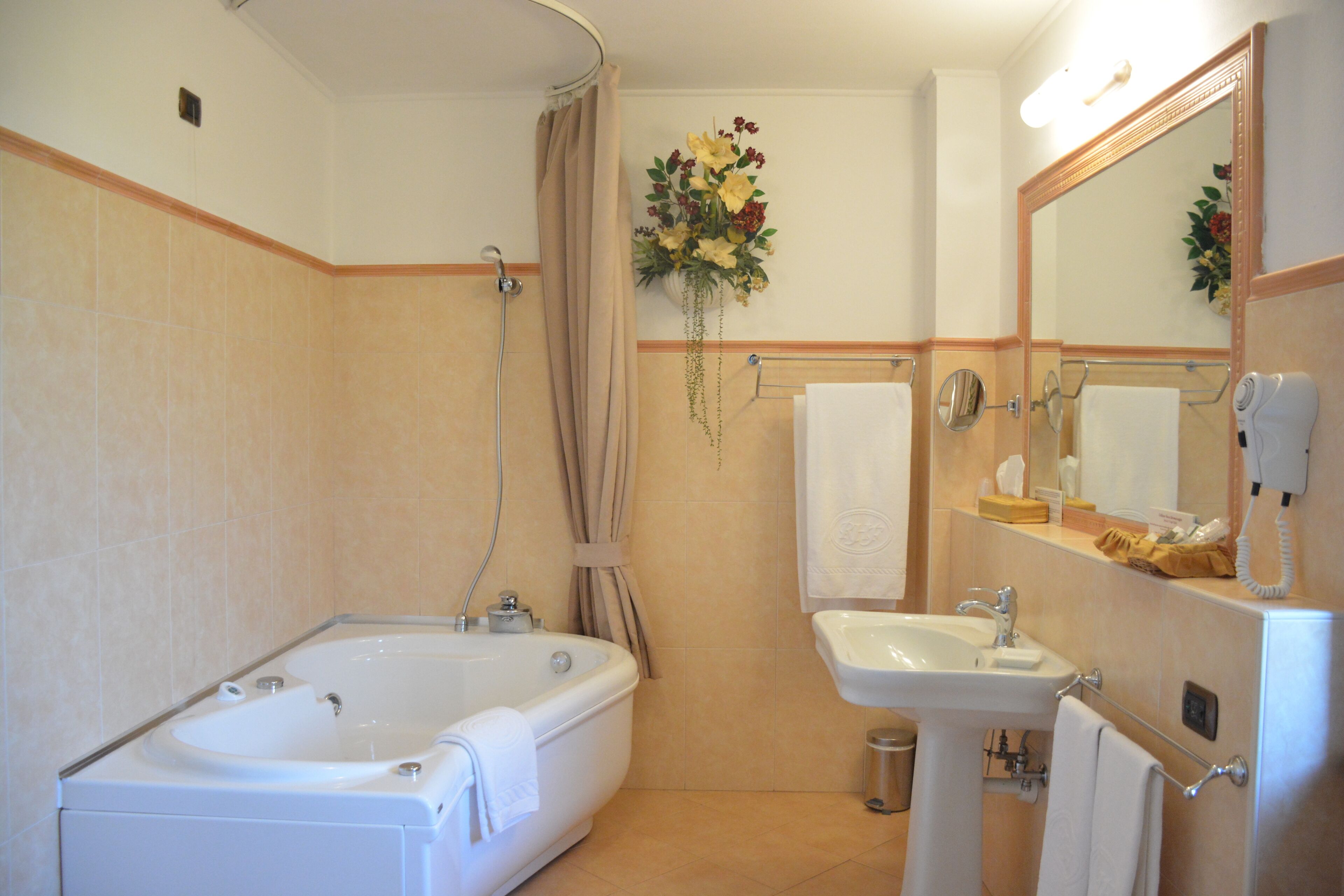 junior suite | bathroom | hair dryer, slippers, bidet, towels
