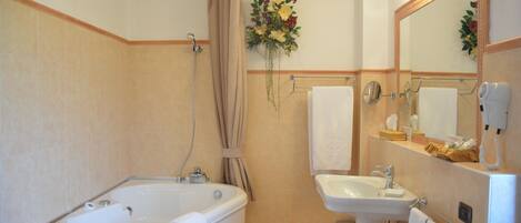 A bathroom with a bathtub, sink, and mirror.