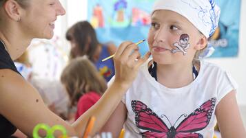 Children can enjoy face painting in a vibrant community space.