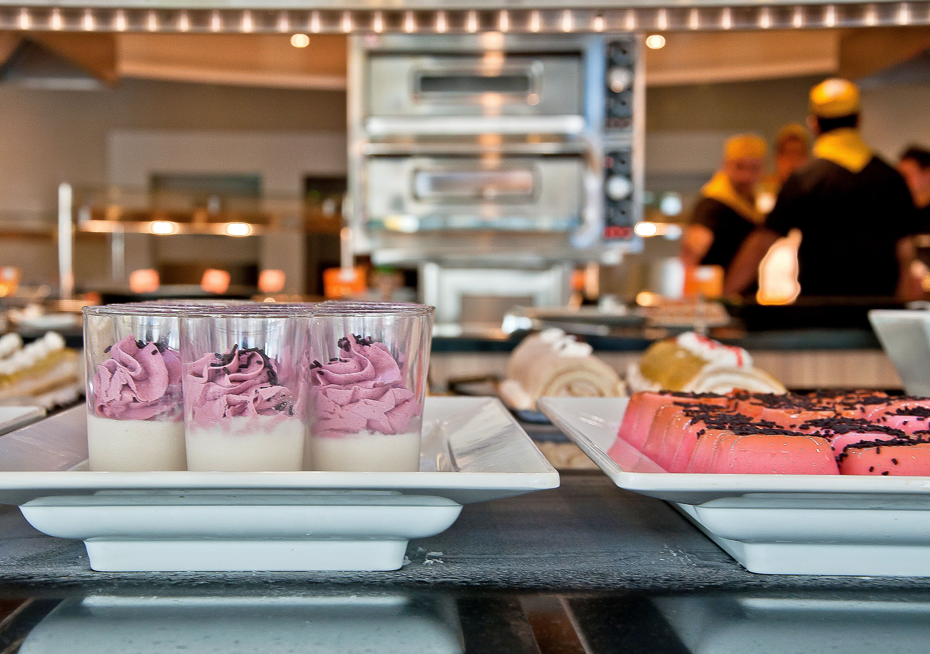 A dessert display with various cakes and pastries.