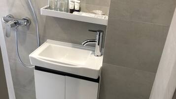 Shower, hair dryer, slippers, towels
