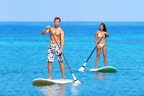 Guests can enjoy stand-up paddleboarding on the calm waters.