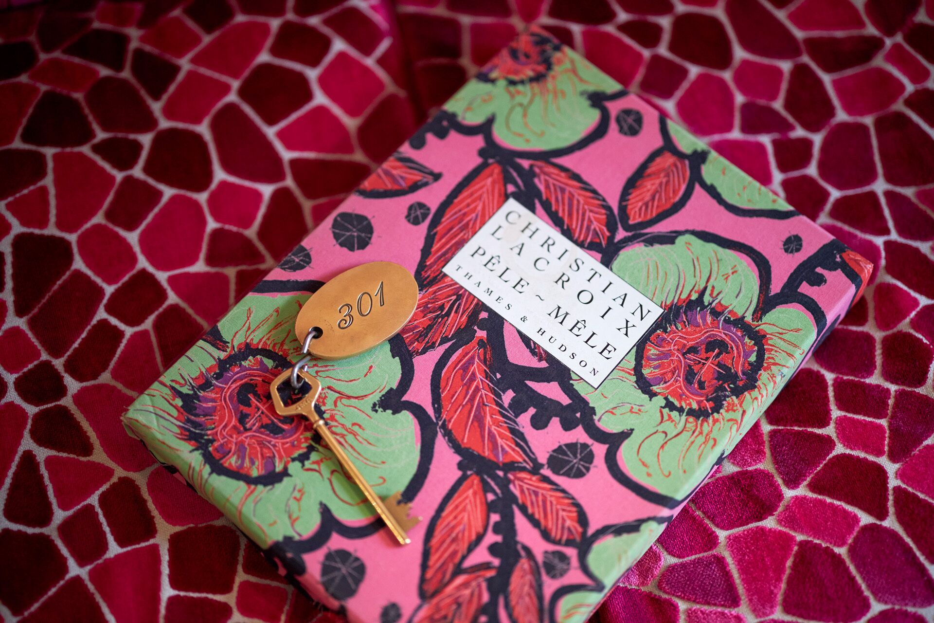 A notebook with a colorful floral pattern and a tag labeled "301".