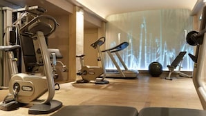 A gym with various exercise equipment including a treadmill, stationary bike, and weight machines. - Hôtel du Petit Moulin, Haute Couture hotel by Lacroix (Paris)