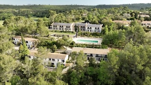 A residential area with multiple houses, including a large building with a swimming pool and solar panels.