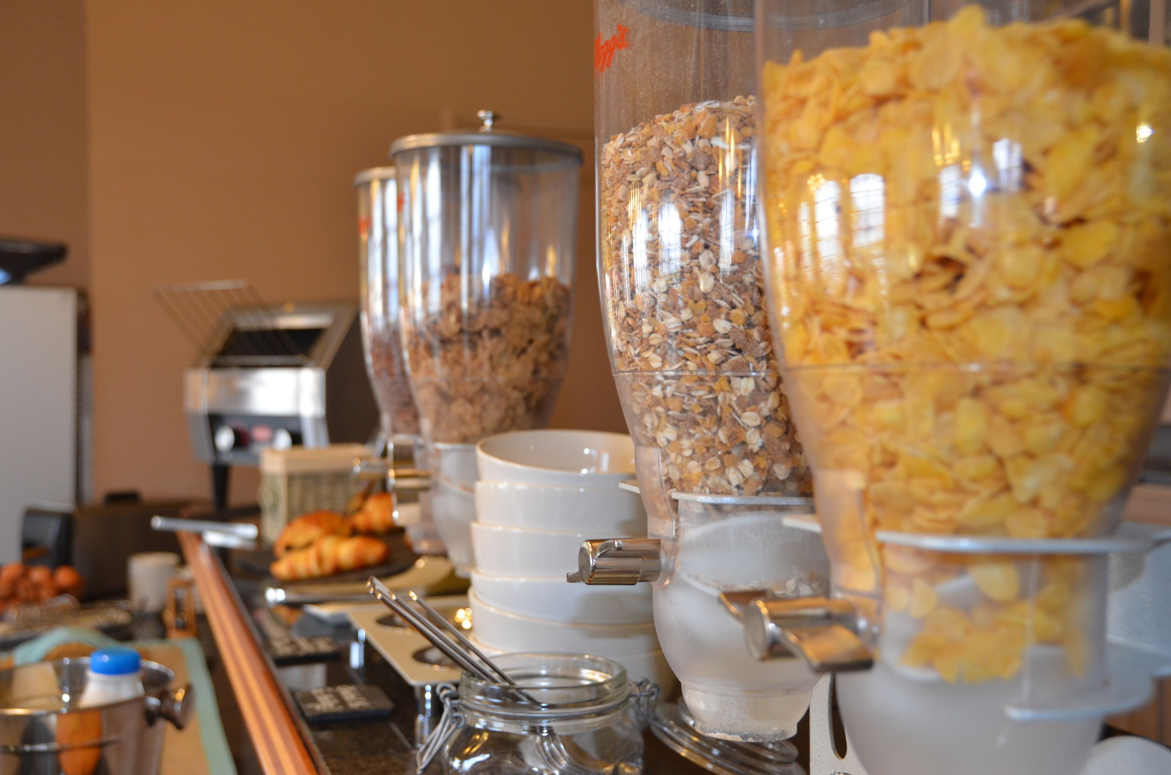 A buffet setup with various food items and containers.