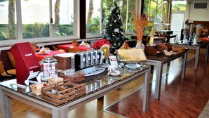 Un bufé de desayuno con diversos alimentos y un árbol de Navidad.