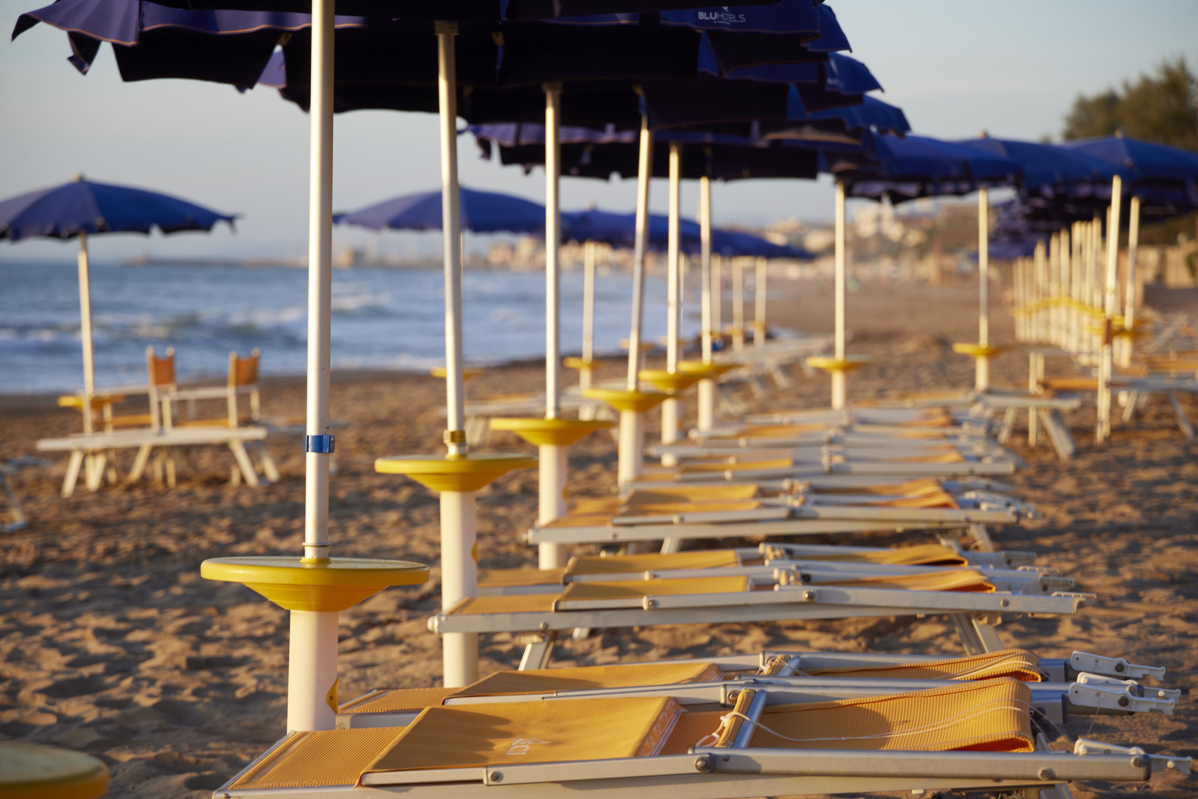on the beach, beach umbrellas, beach towels