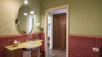 A bathroom with a sink, mirror, and toilet.