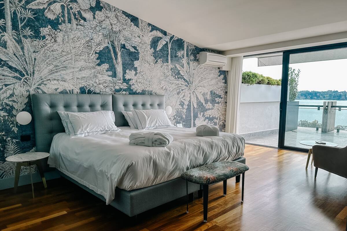 Panoramic Suite, Balcony, Lake View | Minibar, in-room safe, desk, laptop workspace