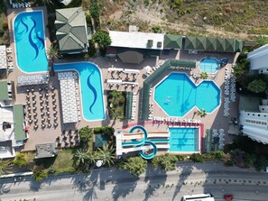 An aerial view of a resort with multiple swimming pools, sun loungers, and a water slide. -  Aydinbey Gold Dreams - Ultra All Inclusive (Alanya)