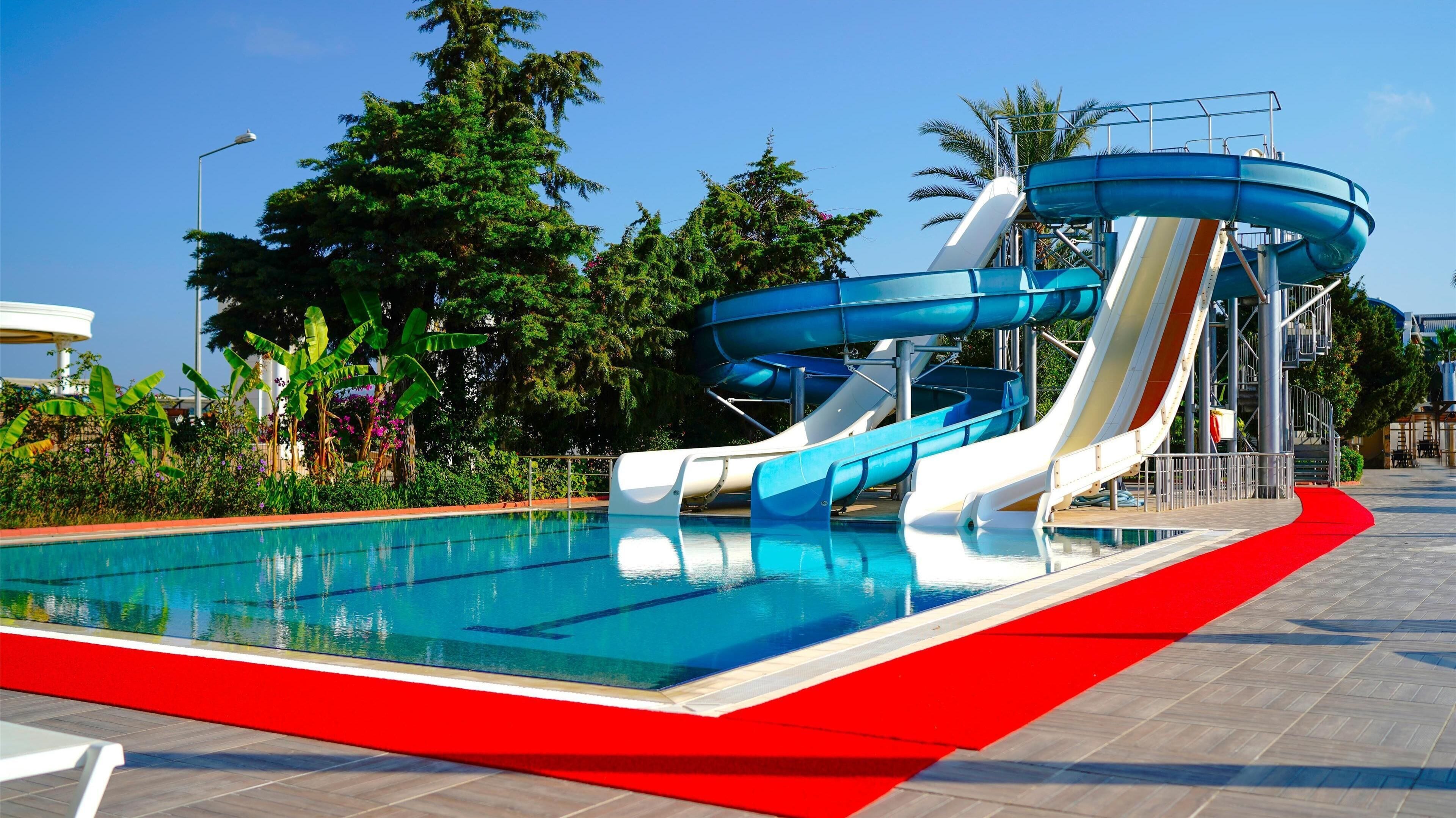 A water park with multiple slides and a pool.