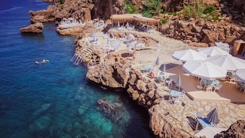 On the beach, sun-loungers, beach umbrellas, beach towels